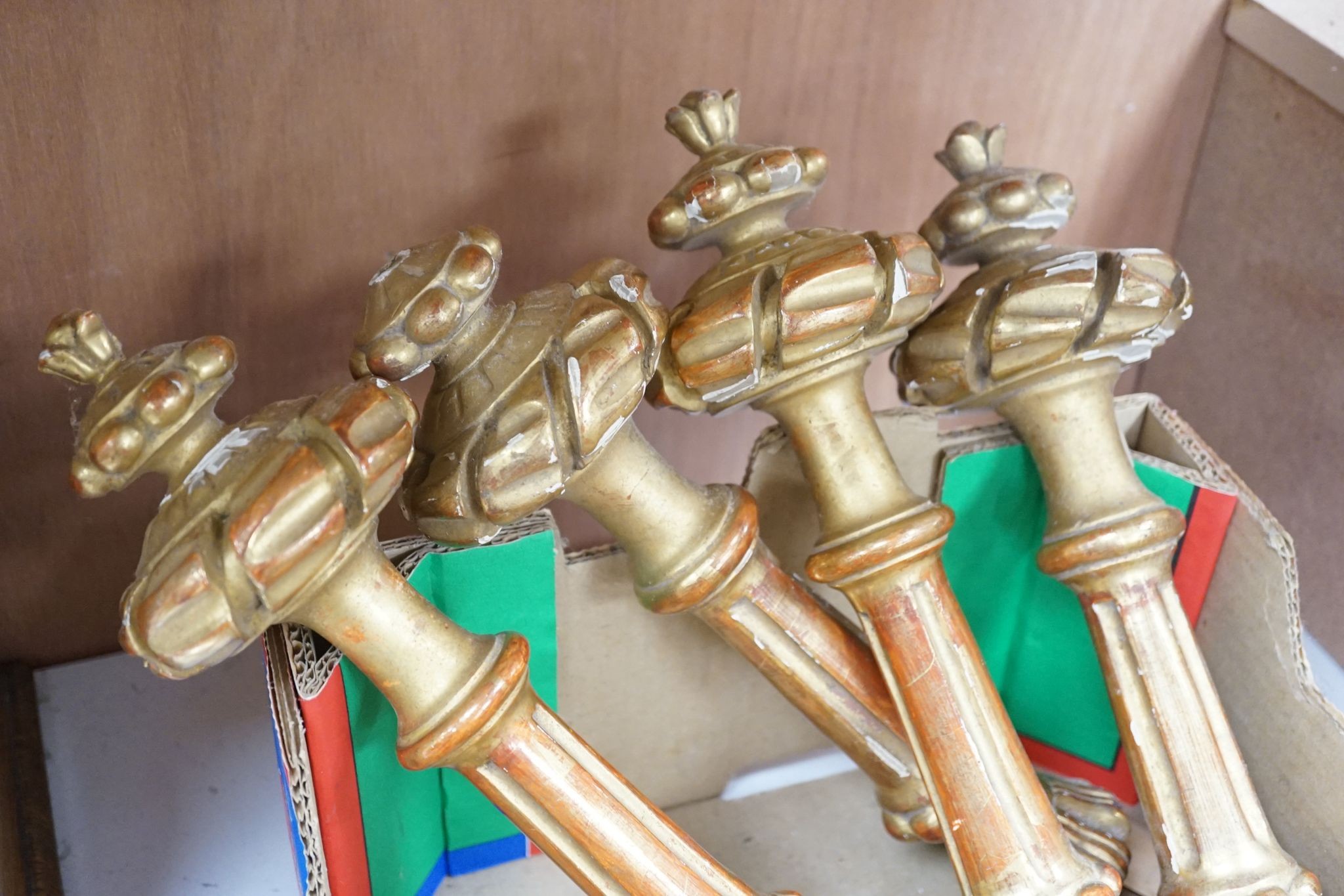 Two sets of four giltwood curtain tie/hold backs, Longest 31 cms.